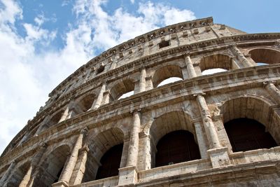 Low angle view of historical building against cloudy sky