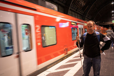 Rear view of man standing in train