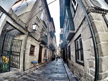Narrow alley amidst buildings in city