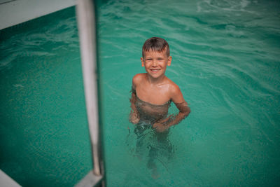 Portrait of smiling boy in swimming pool