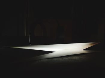 Close-up of illuminated electric lamp against black background