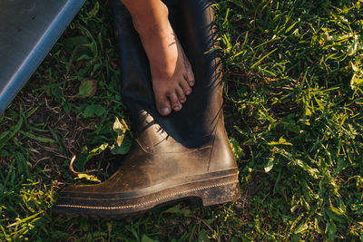 Low section of person on boot over grass