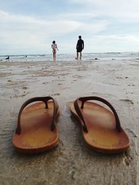 People on beach against sky