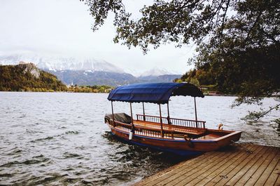 Boat in lake bled against autumn sky