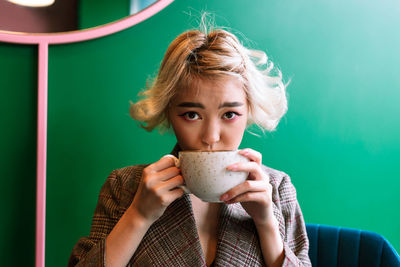 Portrait of woman holding coffee cup