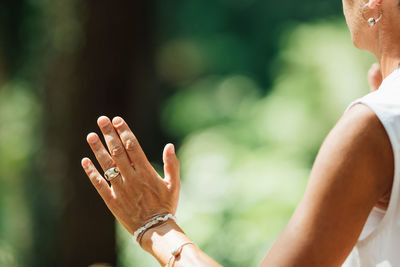 Middle aged woman practicing tai chi chuan in the park. close up on hands position