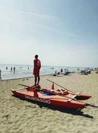 Man standing on boat at breach against sky