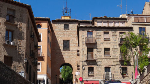 Low angle view of buildings against blue sky