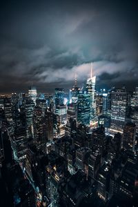 High angle view of city lit up at night