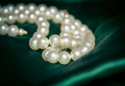 Close-up of wedding rings on white table