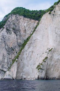 Rock formations by sea against sky