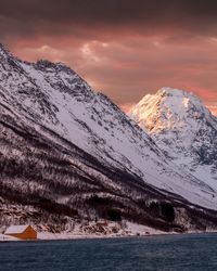 Scenic view of snowcapped mountains against sky during sunset