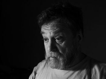 Portrait of man against black background