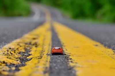 Close-up of red toy car on road