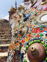 Low angle view of buddha statue against sky