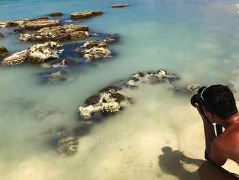 High angle view of boy in sea against sky
