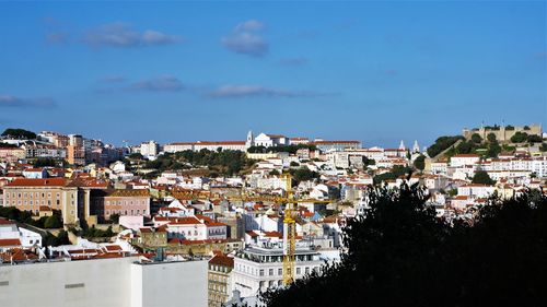 Buildings in town against sky