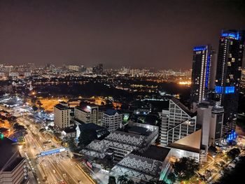 High angle view of illuminated buildings against sky at night