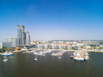 Aerial view of buildings in city against sky