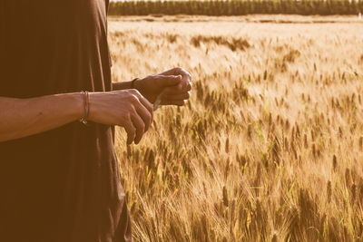 Midsection of man at wheat field