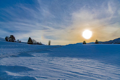 Scenic view of snow against sky during sunset