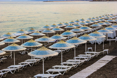 High angle view of lounge chairs and umbrellas at beach