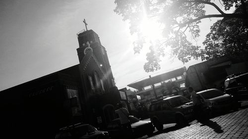 Low angle view of people in city on sunny day