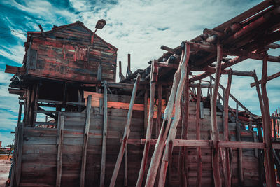 Low angle view of old construction on salt mine against sky