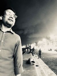 Young man standing on street in city