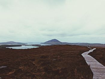 Scenic view of landscape against cloudy sky