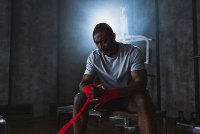 Side view of man exercising in workshop