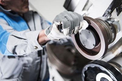 Midsection of man working in factory