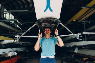 Portrait of boy standing in boat