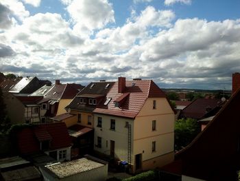 Residential buildings against cloudy sky