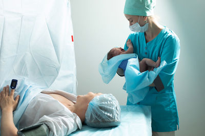 Side view of doctor examining patient at clinic