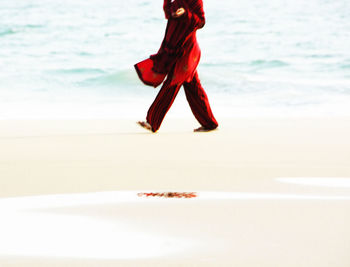 Low section of woman standing on beach