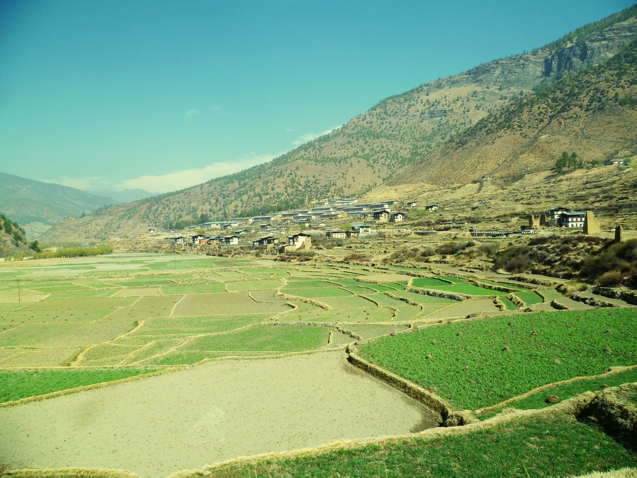 mountain, landscape, tranquil scene, grass, tranquility, scenics, green color, beauty in nature, hill, mountain range, nature, field, clear sky, built structure, non-urban scene, sky, house, rural scene, building exterior, architecture