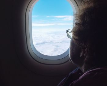 Portrait of man seen through airplane window