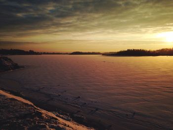 Scenic view of lake at sunset