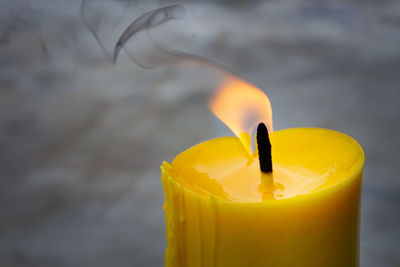 Close-up of yellow lit candle