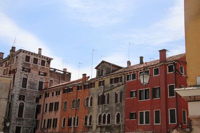 Low angle view of buildings in town against sky