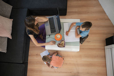 High angle view of woman using laptop on table