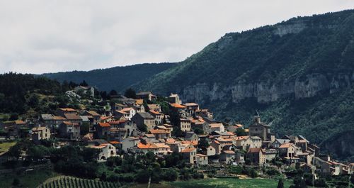 Houses on mountain against sky