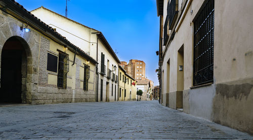 Walkway amidst buildings in city