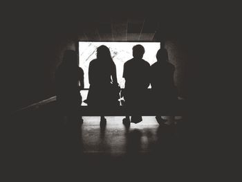 Silhouette people standing in corridor