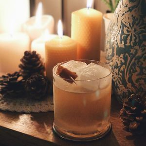 Close-up of orange drink on table in candle light