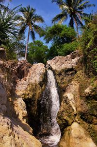 Scenic view of waterfall against sky