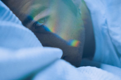 Close-up portrait of man with spectrum on face