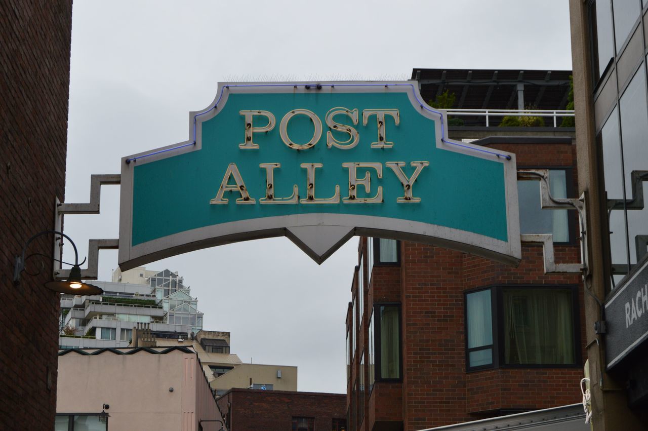 architecture, building exterior, built structure, low angle view, text, western script, communication, window, building, city, residential building, sky, sign, information sign, residential structure, capital letter, day, outdoors, information, no people