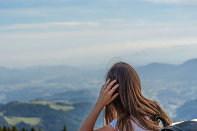 Rear view of woman against hills and valley. view, landscape.